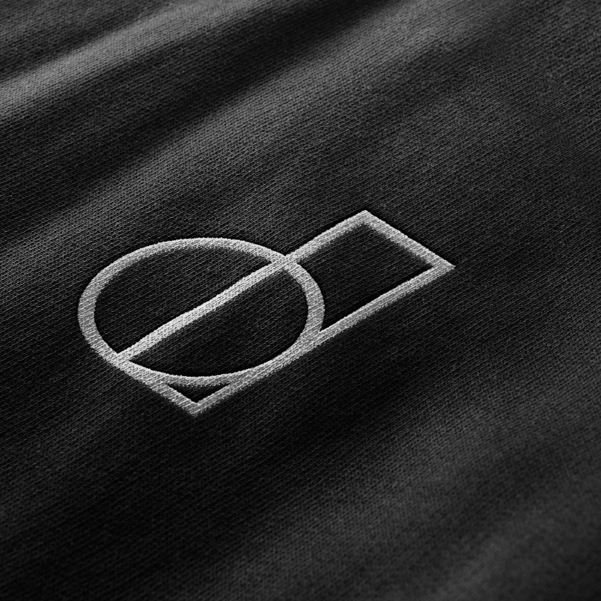 District 150 - Embossed logo on dark textured material