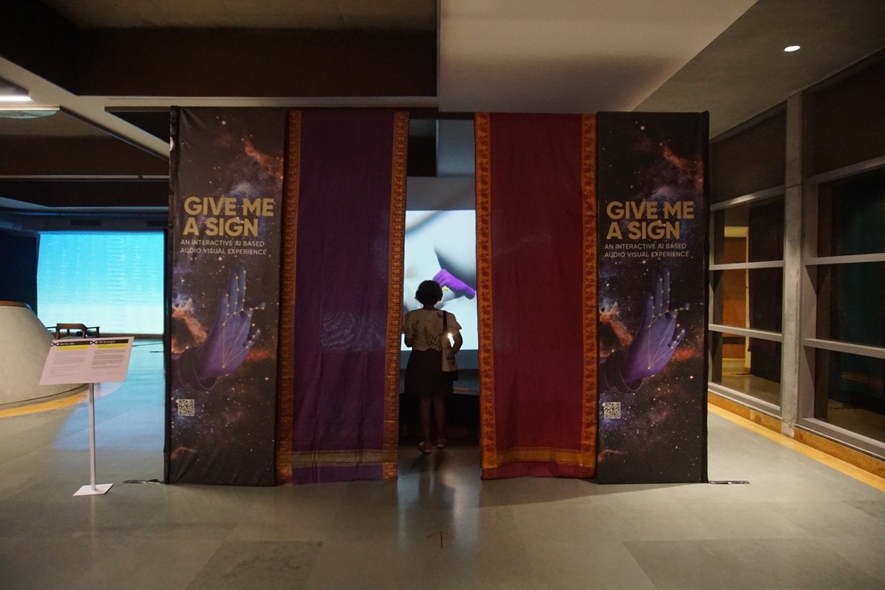 Give Me a Sign - Immersive installation entrance with thematic panels