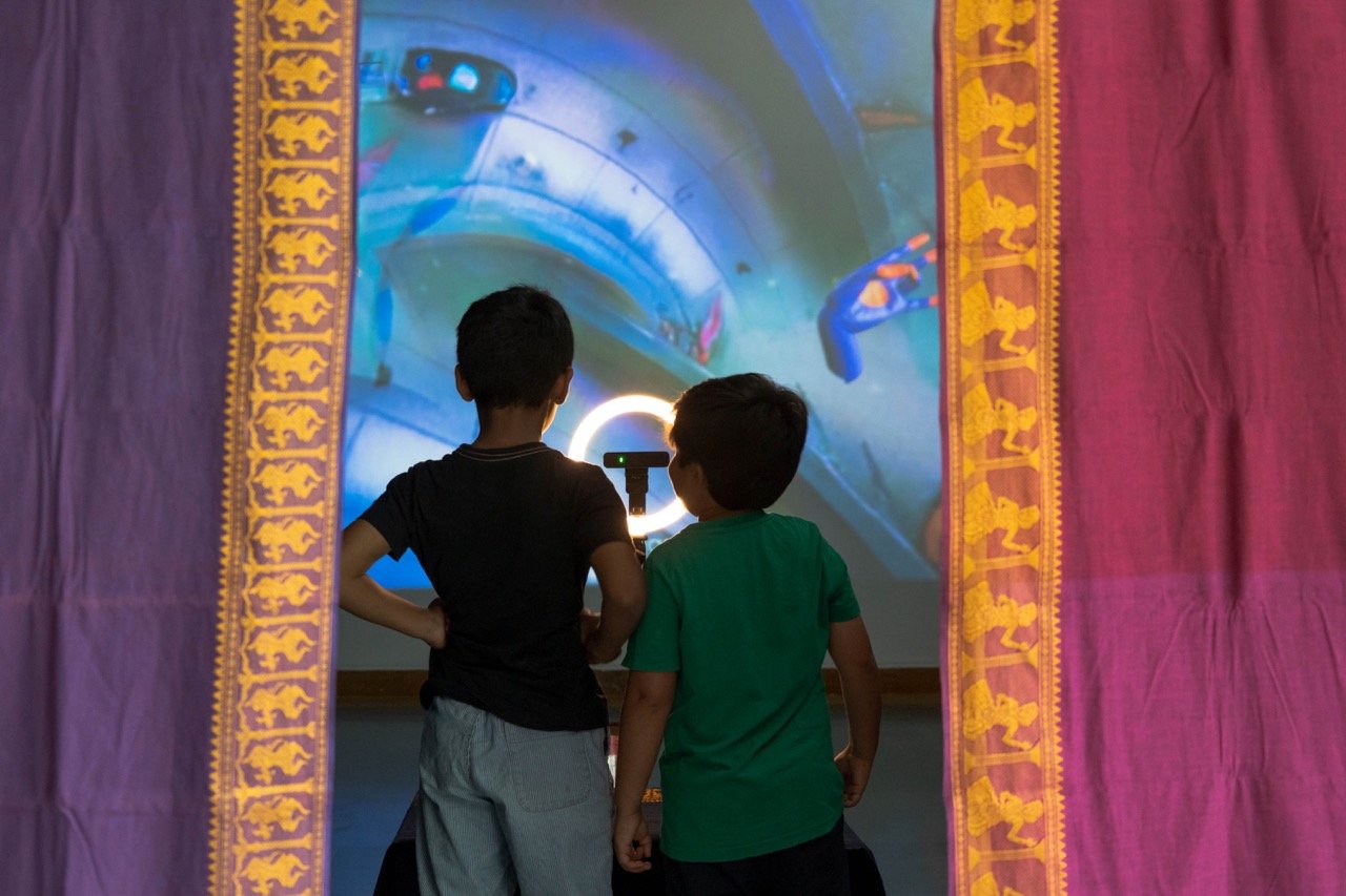 Give Me a Sign - Children interacting with Earth & Water theme through draped entrance