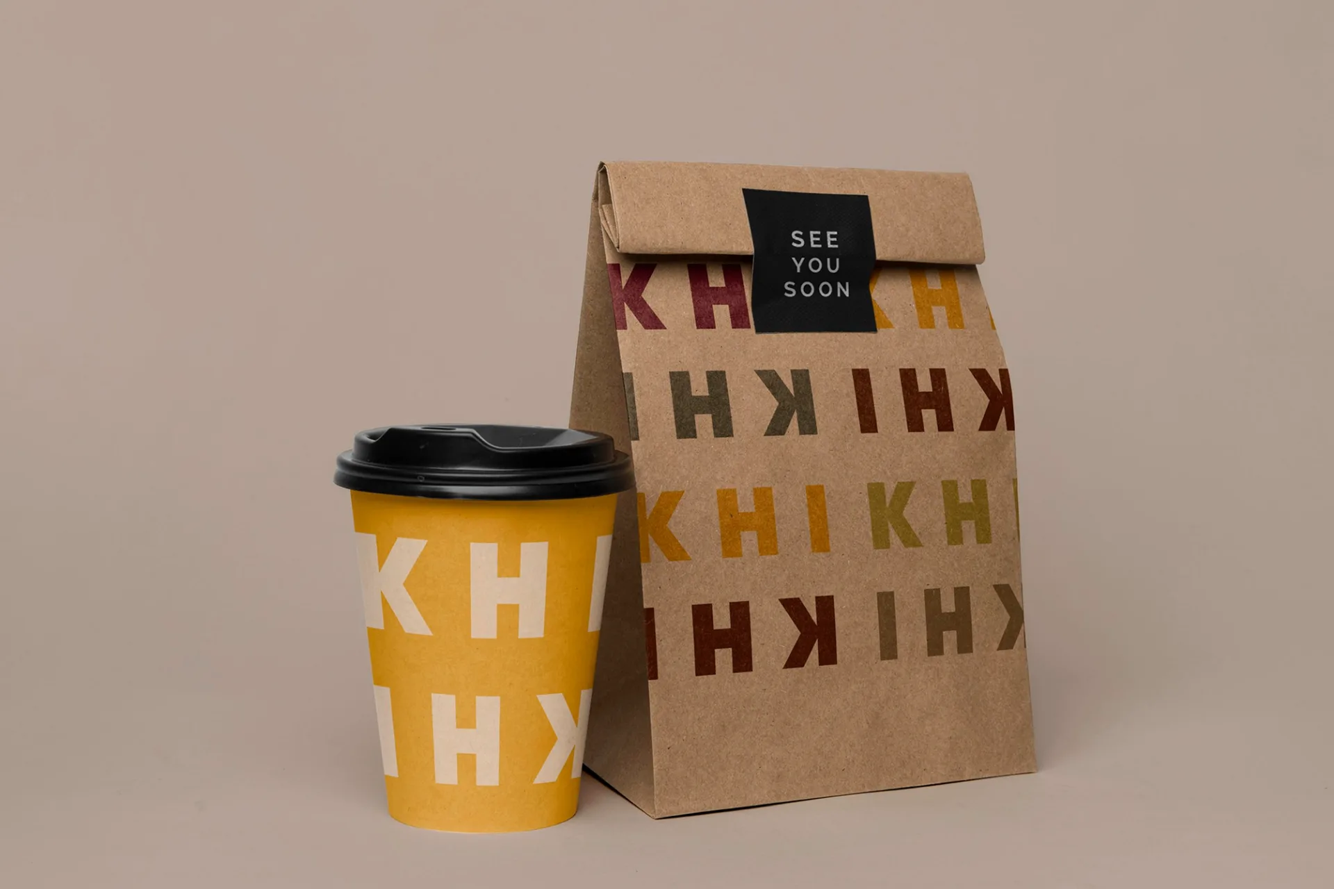 KHI KHI takeaway packaging with coffee cup and bag featuring colorful logo pattern and 'SEE YOU SOON' message