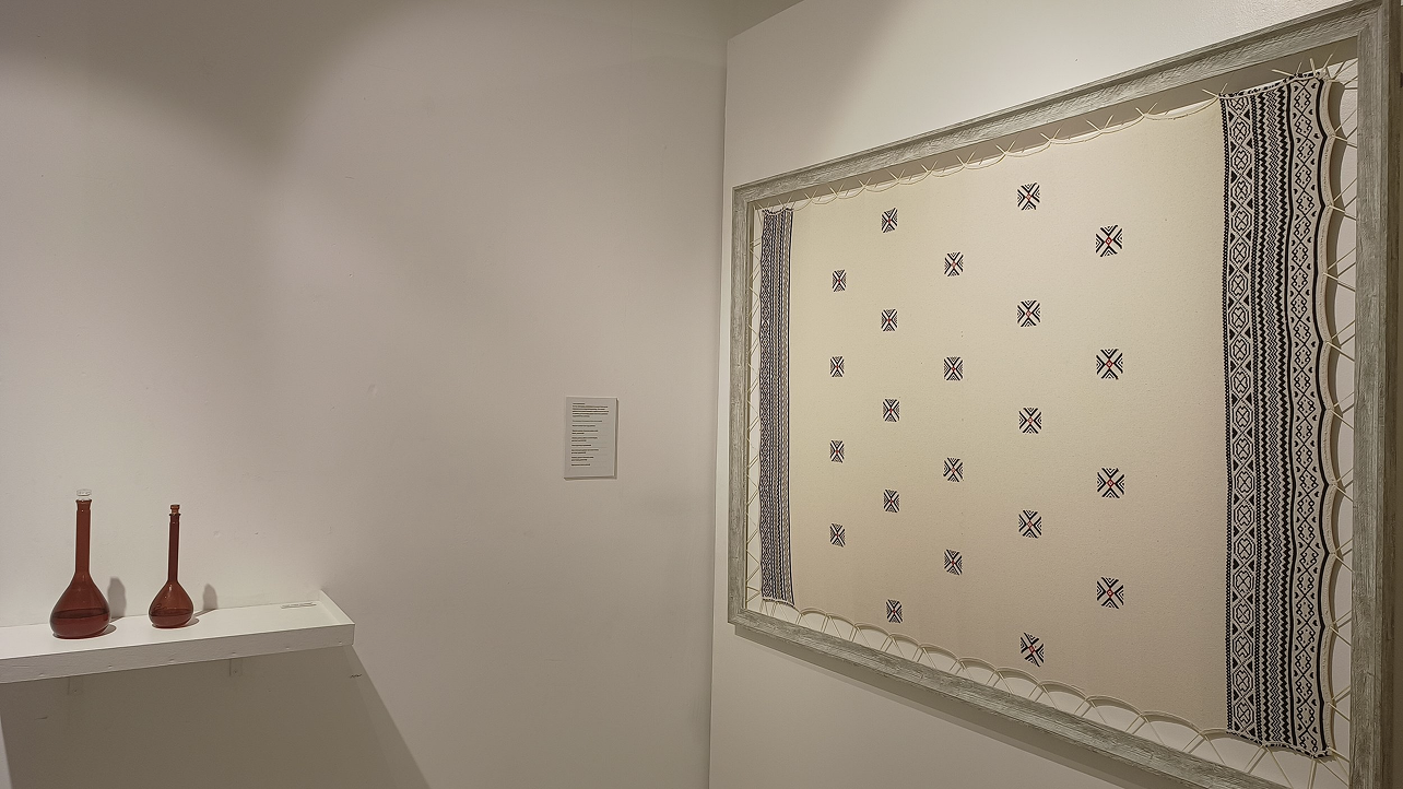 Traditional textile pattern display featuring geometric designs in contemporary gallery setting